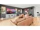 Stylish living room with leather furniture, modern decor, and a large television for entertainment at 9391 E 59Th North Pl, Denver, CO 80238