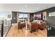 Chic living room showcasing modern design with comfortable leather chairs and a sliding glass door to the balcony at 9391 E 59Th North Pl, Denver, CO 80238