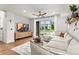 Inviting living room featuring a comfortable sectional sofa and sliding glass doors at 9391 E 59Th North Pl, Denver, CO 80238