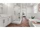 Bright main bathroom showcasing the walk-in shower, freestanding tub, and vanity with ample lighting at 9391 E 59Th North Pl, Denver, CO 80238