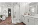 Bright main bathroom featuring Herringbone tile flooring, walk-in shower, and double sink vanity at 9391 E 59Th North Pl, Denver, CO 80238