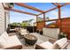 Outdoor patio with fireplace, seating, and pergola overlooking the neighborhood at 9391 E 59Th North Pl, Denver, CO 80238