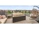 Relaxing rooftop deck area with comfortable seating, including a hanging chair and fire pit feature at 9391 E 59Th North Pl, Denver, CO 80238