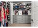 Organized walk-in closet featuring extensive shelving, drawers, and ample storage space at 9391 E 59Th North Pl, Denver, CO 80238