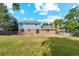 Exterior of home showing backyard, large green grass area, brick and siding exterior, and patio at 4522 S Robb St, Littleton, CO 80127