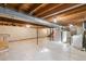 Unfinished basement with concrete floor, exposed wood ceiling and utility equipment at 4522 S Robb St, Littleton, CO 80127