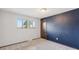 Bedroom with a window, neutral carpet and one dark-blue wall at 4522 S Robb St, Littleton, CO 80127