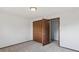 Bedroom with neutral carpet, white walls, window and a door at 4522 S Robb St, Littleton, CO 80127