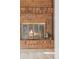 Brick fireplace with glass doors and antique fireplace tools at 4522 S Robb St, Littleton, CO 80127