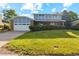 Two-story home with brick and blue siding, featuring a two-car garage and a well-manicured front lawn at 4522 S Robb St, Littleton, CO 80127