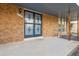 Covered front porch with brick facade and decorative security door at 4522 S Robb St, Littleton, CO 80127