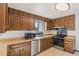 Traditional kitchen with wood cabinets and modern stainless steel appliances at 4522 S Robb St, Littleton, CO 80127