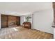 Carpeted living room featuring a fireplace, wood built ins and an upright piano at 4522 S Robb St, Littleton, CO 80127