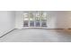 Large living room with bay windows offering ample natural light at 4522 S Robb St, Littleton, CO 80127