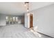Open concept living room featuring large windows and modern lighting at 4522 S Robb St, Littleton, CO 80127