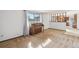 Living room with a piano and large window, leading into the kitchen at 4522 S Robb St, Littleton, CO 80127