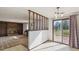 Open-concept living room with fireplace, tile floors, and natural light from sliding glass door at 4522 S Robb St, Littleton, CO 80127