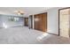 Spacious main bedroom with neutral carpet, ceiling fan, three windows and closet at 4522 S Robb St, Littleton, CO 80127