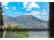 Window view of mountain range, with a clear, blue sky, green trees, and greenery at 4522 S Robb St, Littleton, CO 80127
