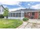 This property features a sunroom addition and a well-maintained yard at 4453 Fillmore St, Denver, CO 80216