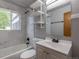 Updated bathroom featuring modern fixtures, shower over tub and decorative shelving at 4453 Fillmore St, Denver, CO 80216