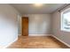 A bedroom is illuminated by a flush mount light fixture, with hardwood floors and grey walls at 4453 Fillmore St, Denver, CO 80216