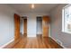 This bedroom has hardwood floors, light grey walls, and closet space at 4453 Fillmore St, Denver, CO 80216