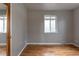 This bedroom has hardwood floors, light grey walls, and natural light from the window at 4453 Fillmore St, Denver, CO 80216