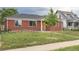 Simple single-story brick house with a neat yard and a small tree near the walkway at 4453 Fillmore St, Denver, CO 80216
