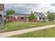Street-level view of single story brick home and small tree in the yard at 4453 Fillmore St, Denver, CO 80216