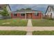 Charming single-story brick home with a well-manicured lawn and inviting walkway at 4453 Fillmore St, Denver, CO 80216