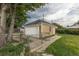 Detached garage with white door and neutral paint and chain link fence adding security and curb appeal at 4453 Fillmore St, Denver, CO 80216