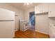 A kitchen with traditional decor, featuring white appliances and access to other rooms at 4453 Fillmore St, Denver, CO 80216