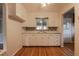 Bright kitchen with white cabinets, mosaic tile backsplash, hardwood floors, and a ceiling fan at 4453 Fillmore St, Denver, CO 80216