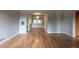 This home's living room features hardwood floors and light grey walls with arched doorways at 4453 Fillmore St, Denver, CO 80216