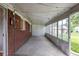 This sunroom has brick walls, a cement floor, and a ceiling lined with string lights at 4453 Fillmore St, Denver, CO 80216