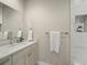 Contemporary bathroom with a vanity, modern fixtures, and a well-lit mirror at 4733 E Iliff Ave, Denver, CO 80222