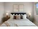Comfortable bedroom featuring a stylish headboard, coordinated decor and natural lighting at 4733 E Iliff Ave, Denver, CO 80222