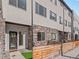 Modern home exterior with stone accents and private fenced front yard at 4733 E Iliff Ave, Denver, CO 80222