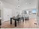Bright living room and dining area featuring a modern chandelier, hardwood floors and neutral color palette at 4733 E Iliff Ave, Denver, CO 80222