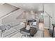 Open-concept living space with a modern interior, kitchen, dining area, and staircase access at 4733 E Iliff Ave, Denver, CO 80222