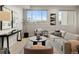 Bright living room with modern furnishings, decor, and a large window providing natural light at 4733 E Iliff Ave, Denver, CO 80222