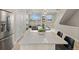 Open-concept living space featuring modern furnishings, dining area, and a spacious kitchen at 4733 E Iliff Ave, Denver, CO 80222