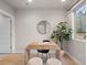 Bright office space with modern desk, decor, plush seating, and natural light from a large window at 4733 E Iliff Ave, Denver, CO 80222