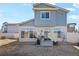 Backyard with a patio area, grill, chairs, and a fire pit for outdoor entertaining at 19055 E 55Th Ave, Denver, CO 80249