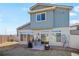 Backyard with a patio area, grill, chairs, and a fire pit for outdoor entertaining at 19055 E 55Th Ave, Denver, CO 80249