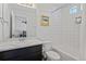 Bright bathroom features a shower-tub and a large mirror with a stylish vanity at 19055 E 55Th Ave, Denver, CO 80249