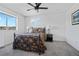 A bedroom with neutral walls, carpet, a dark metal bed frame, and matching end tables with lamps at 19055 E 55Th Ave, Denver, CO 80249