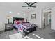 A bedroom features neutral walls, carpet, a dark wood bed frame, and matching end tables with lamps at 19055 E 55Th Ave, Denver, CO 80249