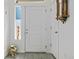 Bright entryway with light gray wood floors, a sidelight window, and a coat closet at 19055 E 55Th Ave, Denver, CO 80249